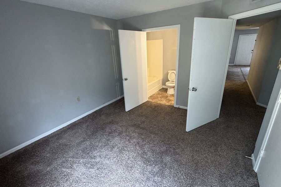 Primary bedroom with a doorway through to its own bathroom