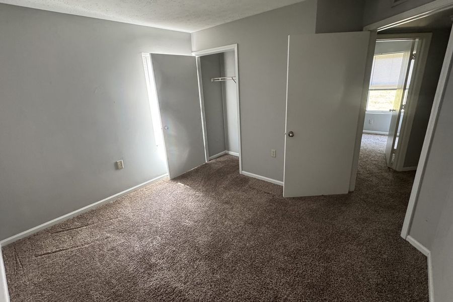 Second bedroom with a closet and a window